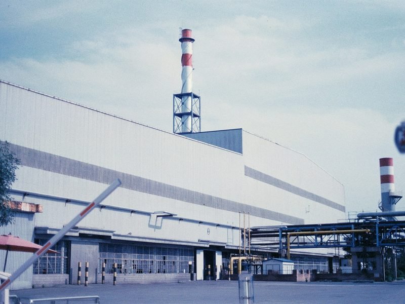 A factory with a boom barrier at the gate
